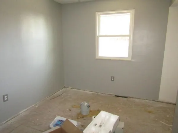 a view of a livingroom with a white car and a window