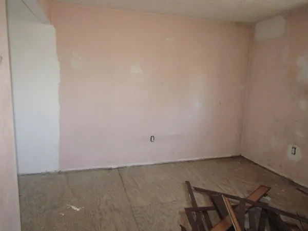 an empty room with wooden floor