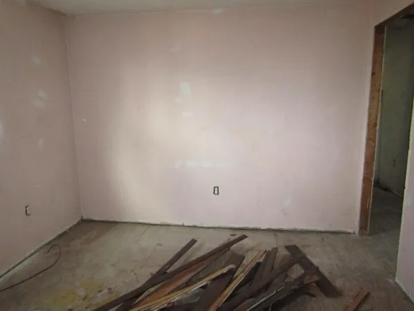 a view of empty room with wooden walls