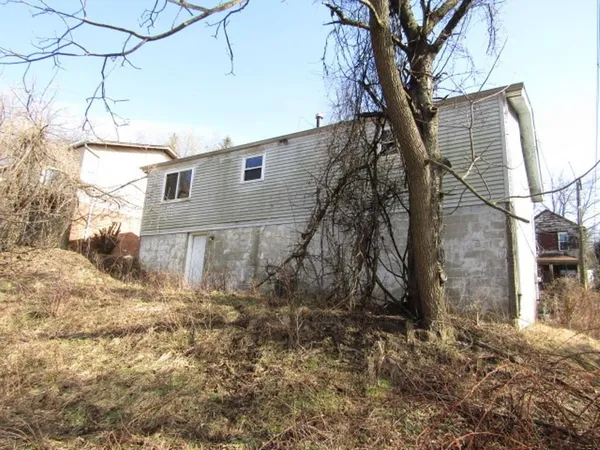 a side view of a house with a yard