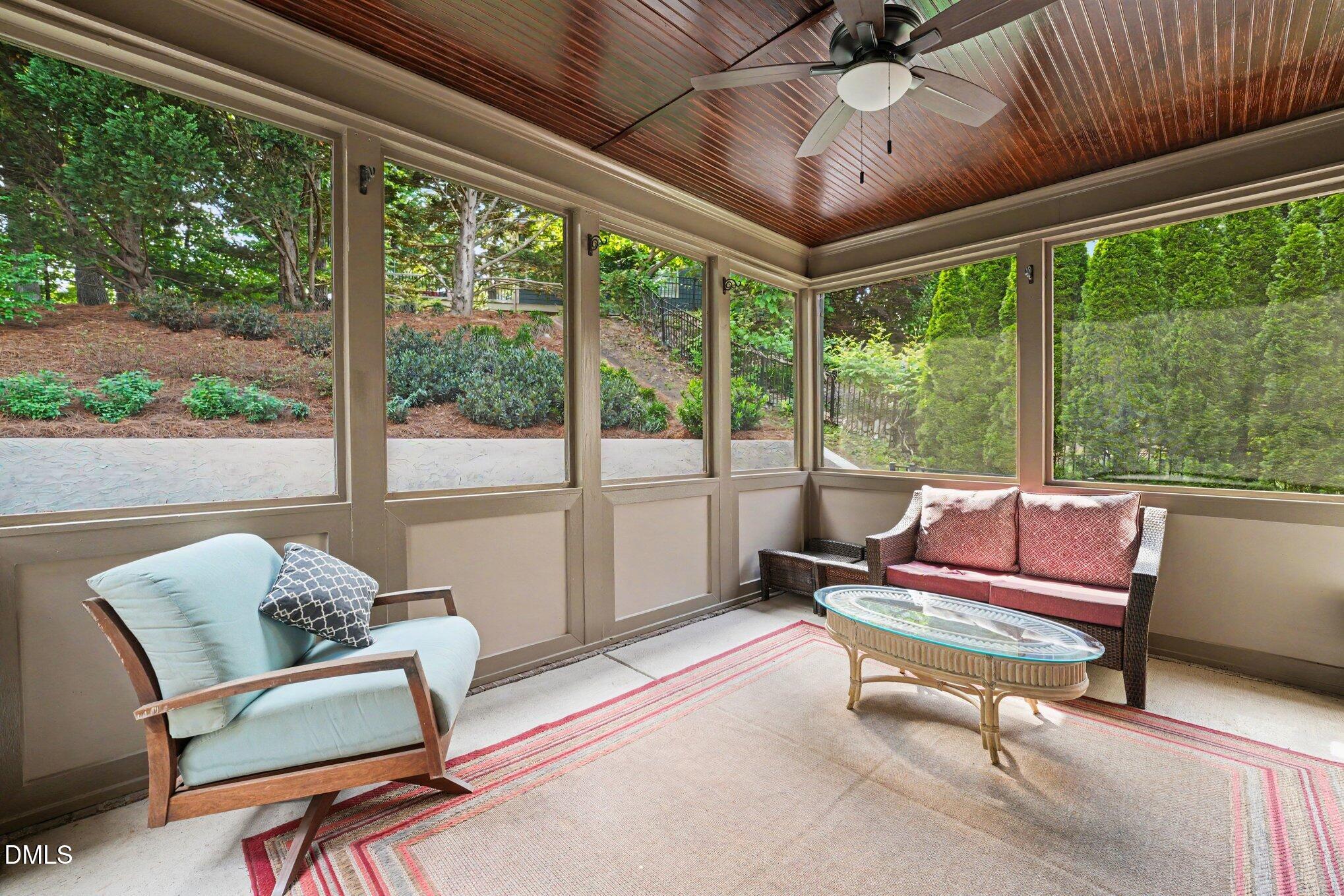 1729 Frenchwood Drive Raleigh, NC 27612 - Photo 35 of 46 a living room with furniture and a floor to ceiling window