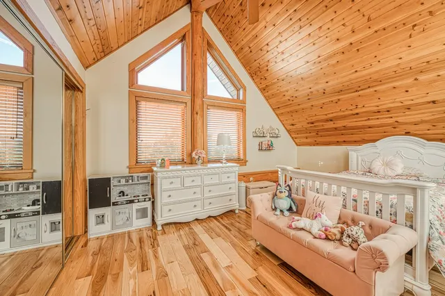 a bedroom with furniture and a large window