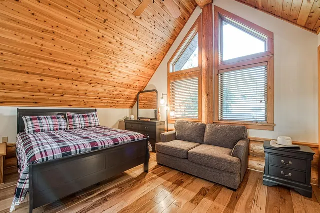 a view of porch with a table and chairs and potted plants