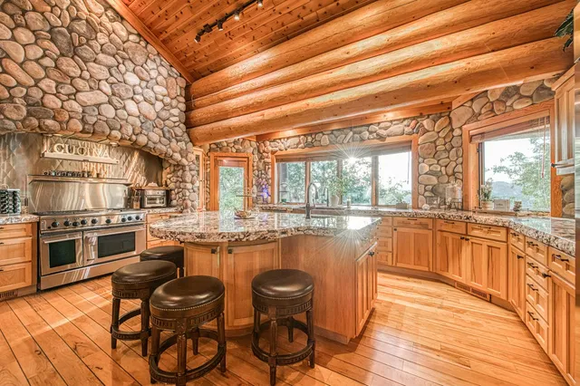 a view of a dining room with furniture a chandelier and wooden floor