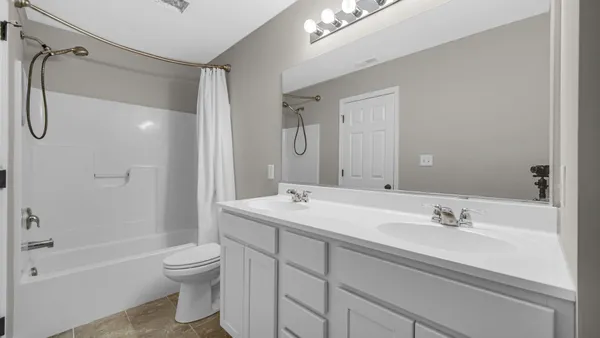 a bathroom with a sink double vanity granite tub and shower