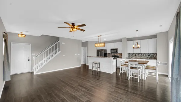 a view of a dining room with furniture and wooden floor