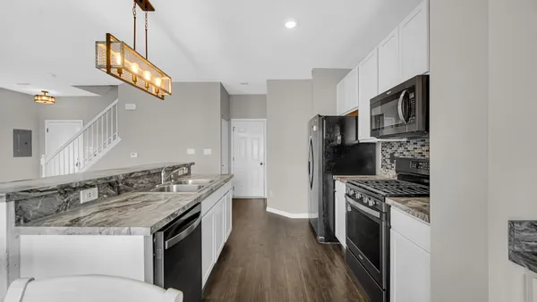 a kitchen with stainless steel appliances granite countertop a stove and a refrigerator