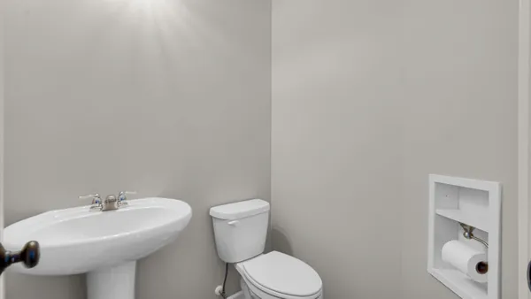 a bathroom with a sink mirror and toilet