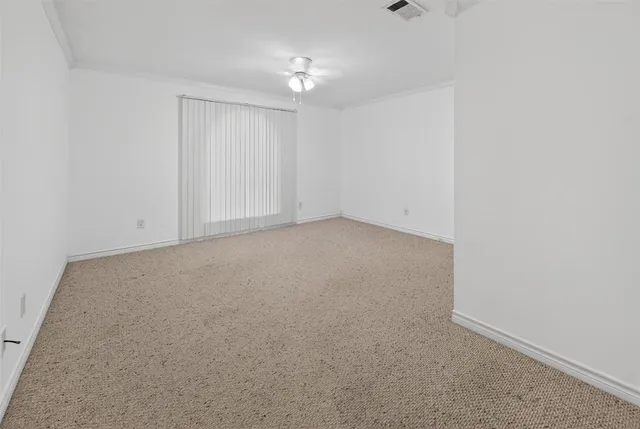 an empty room with a ceiling fan