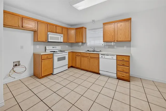 a kitchen with stainless steel appliances granite countertop a sink and cabinets