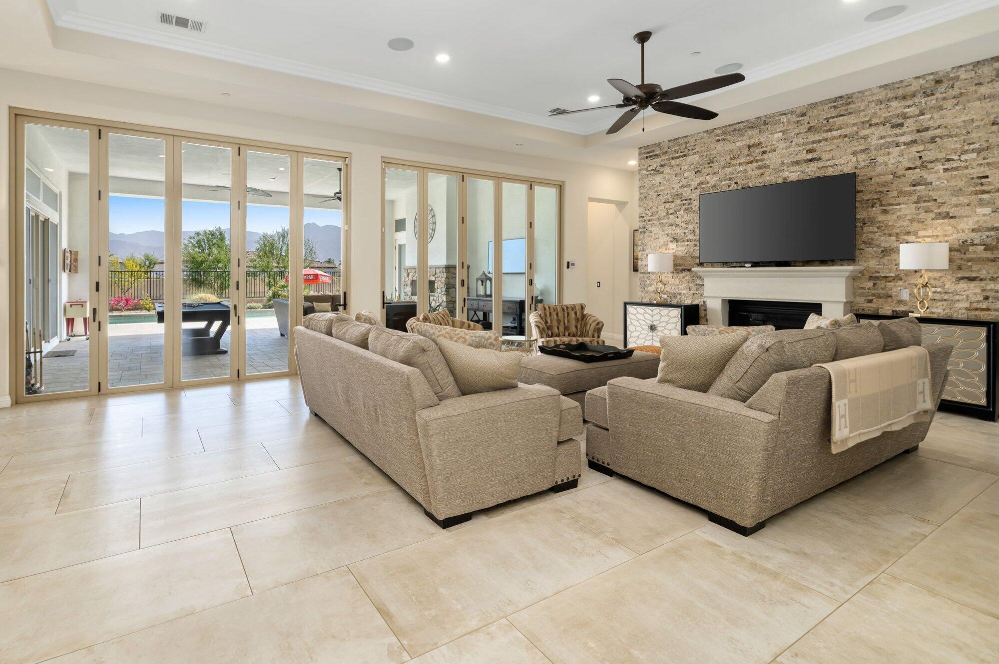 81675 Macbeth Street La Quinta, CA 92253 - Photo 14 of 76 a living room with furniture a flat screen tv and a fireplace