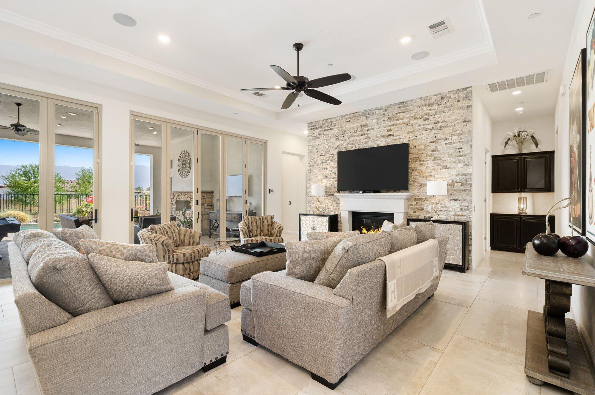 81675 Macbeth Street La Quinta, CA 92253 - Photo 15 of 76 a living room with furniture a flat screen tv and a fireplace