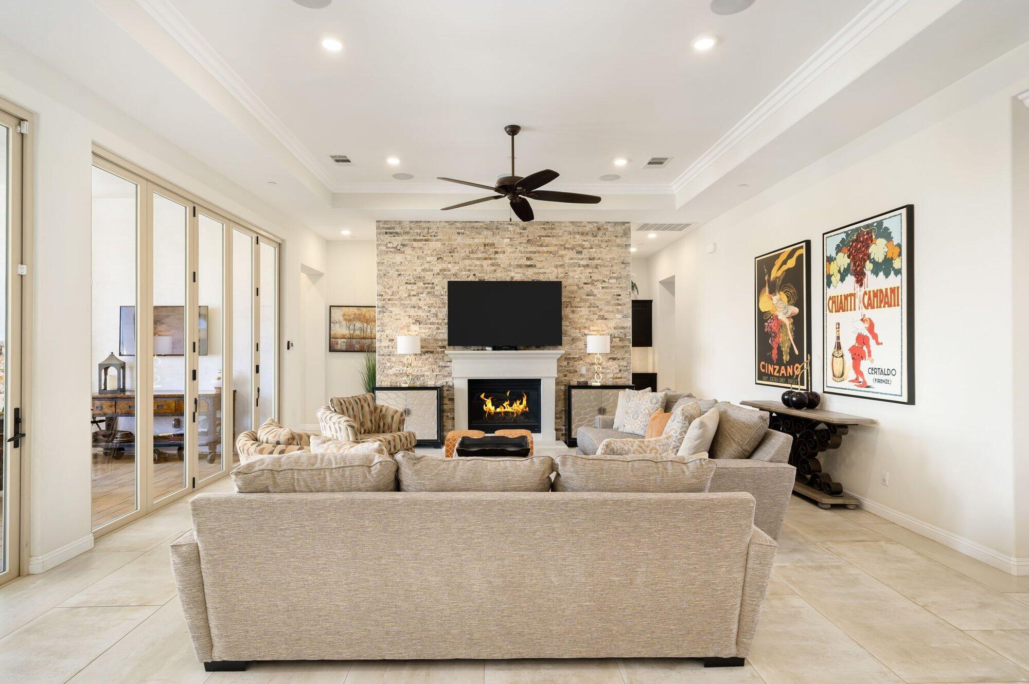 81675 Macbeth Street La Quinta, CA 92253 - Photo 16 of 76 a living room with fireplace furniture and a flat screen tv