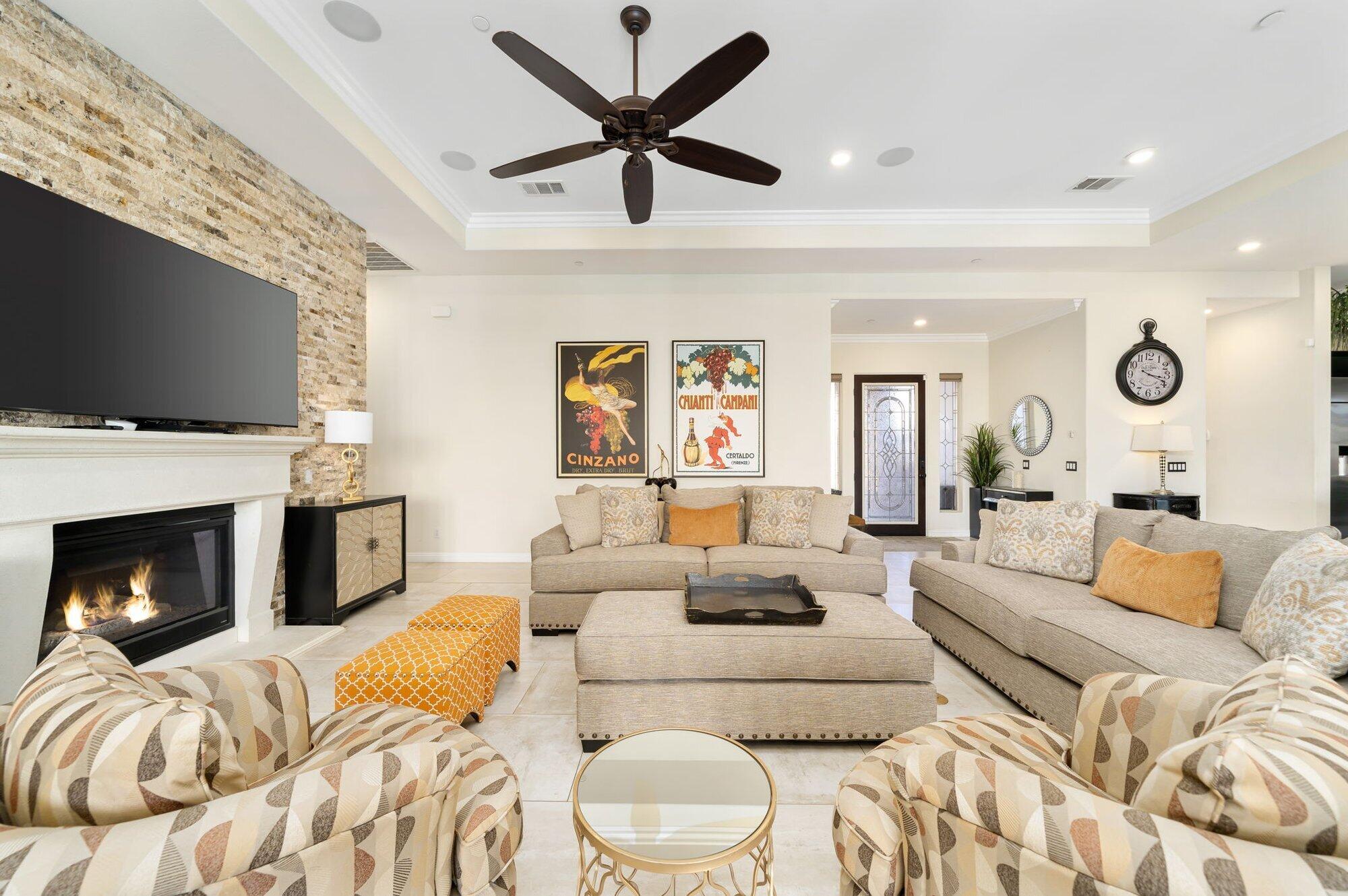 81675 Macbeth Street La Quinta, CA 92253 - Photo 18 of 76 a living room with furniture a fireplace and a flat screen tv