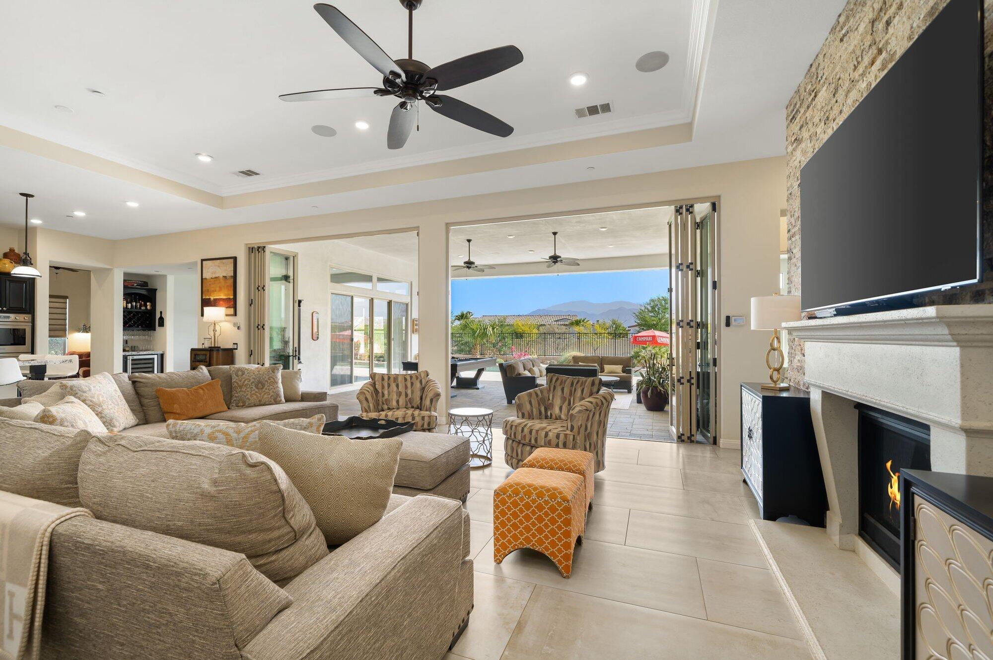 81675 Macbeth Street La Quinta, CA 92253 - Photo 30 of 76 a living room with furniture a fireplace and a flat screen tv
