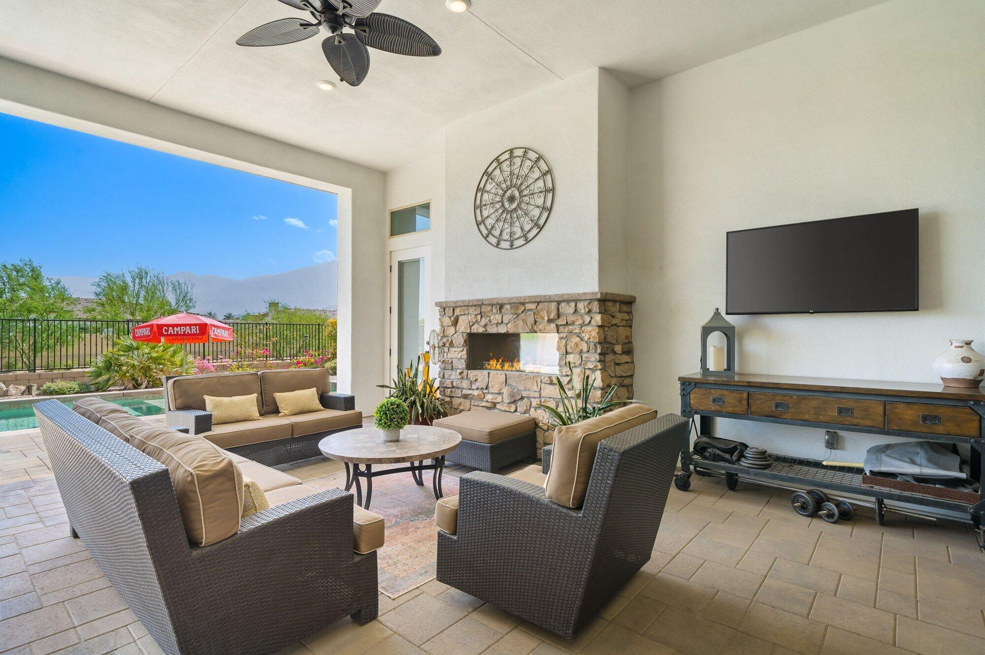 81675 Macbeth Street La Quinta, CA 92253 - Photo 32 of 76 a living room with furniture and a flat screen tv