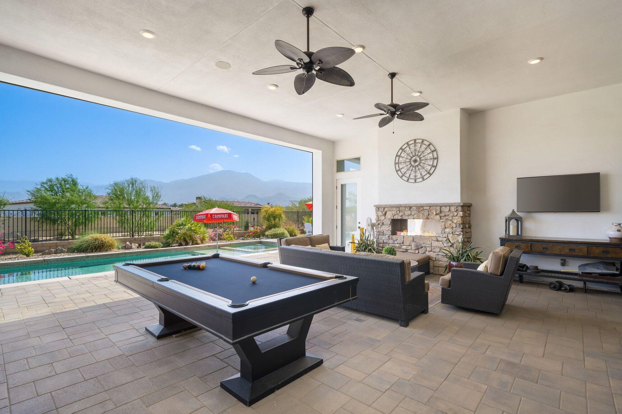 81675 Macbeth Street La Quinta, CA 92253 - Photo 33 of 76 a living room with furniture a pool table and a fireplace