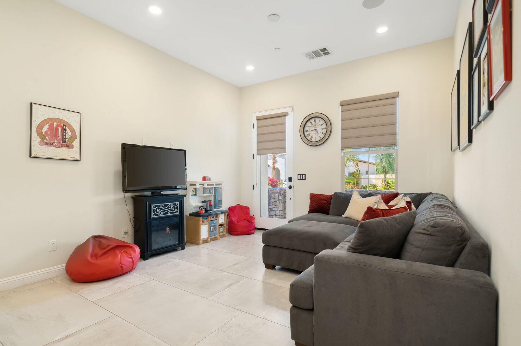 81675 Macbeth Street La Quinta, CA 92253 - Photo 42 of 76 a living room with furniture and a flat screen tv