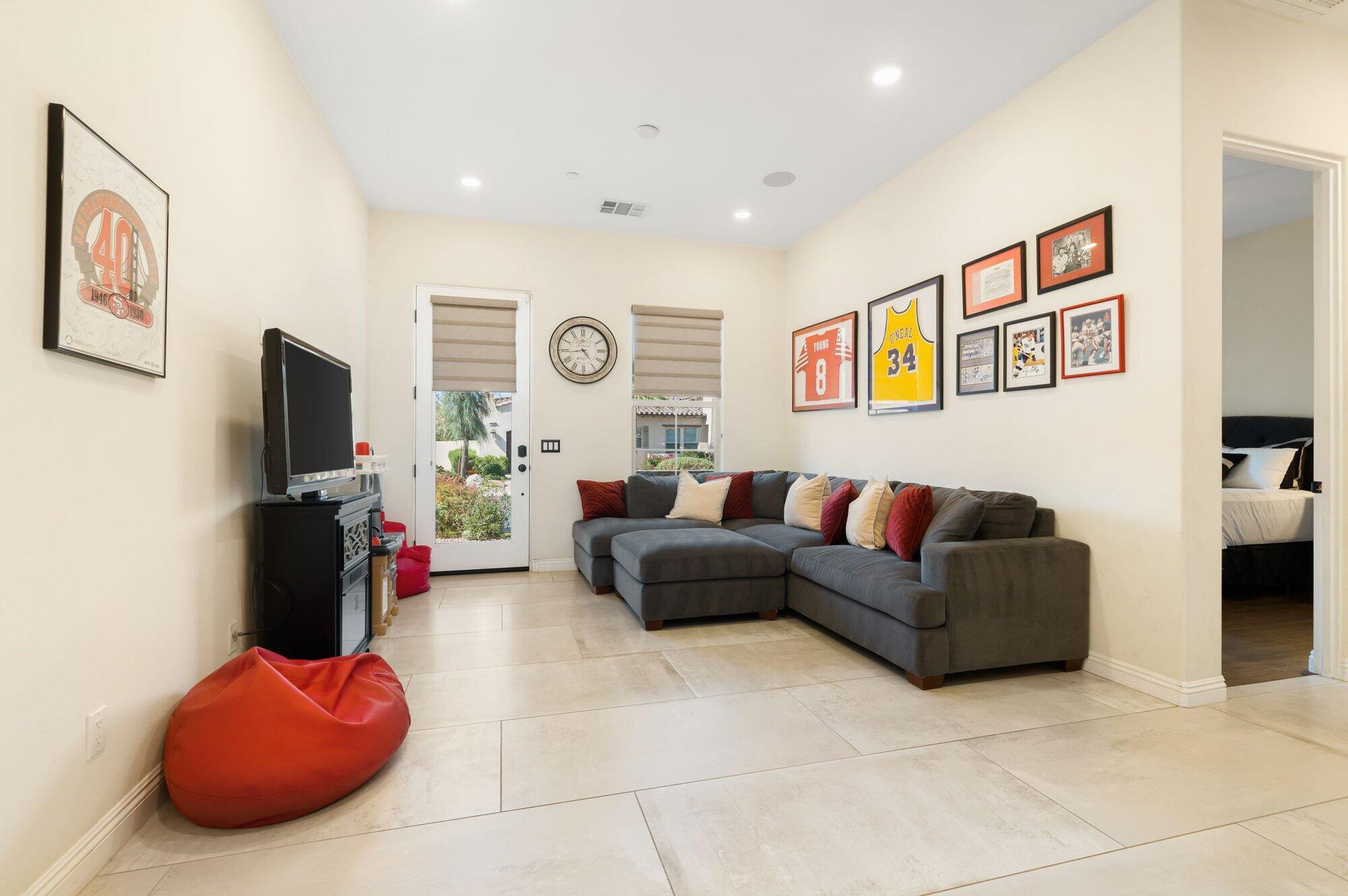 81675 Macbeth Street La Quinta, CA 92253 - Photo 44 of 76 a living room with furniture and a flat screen tv