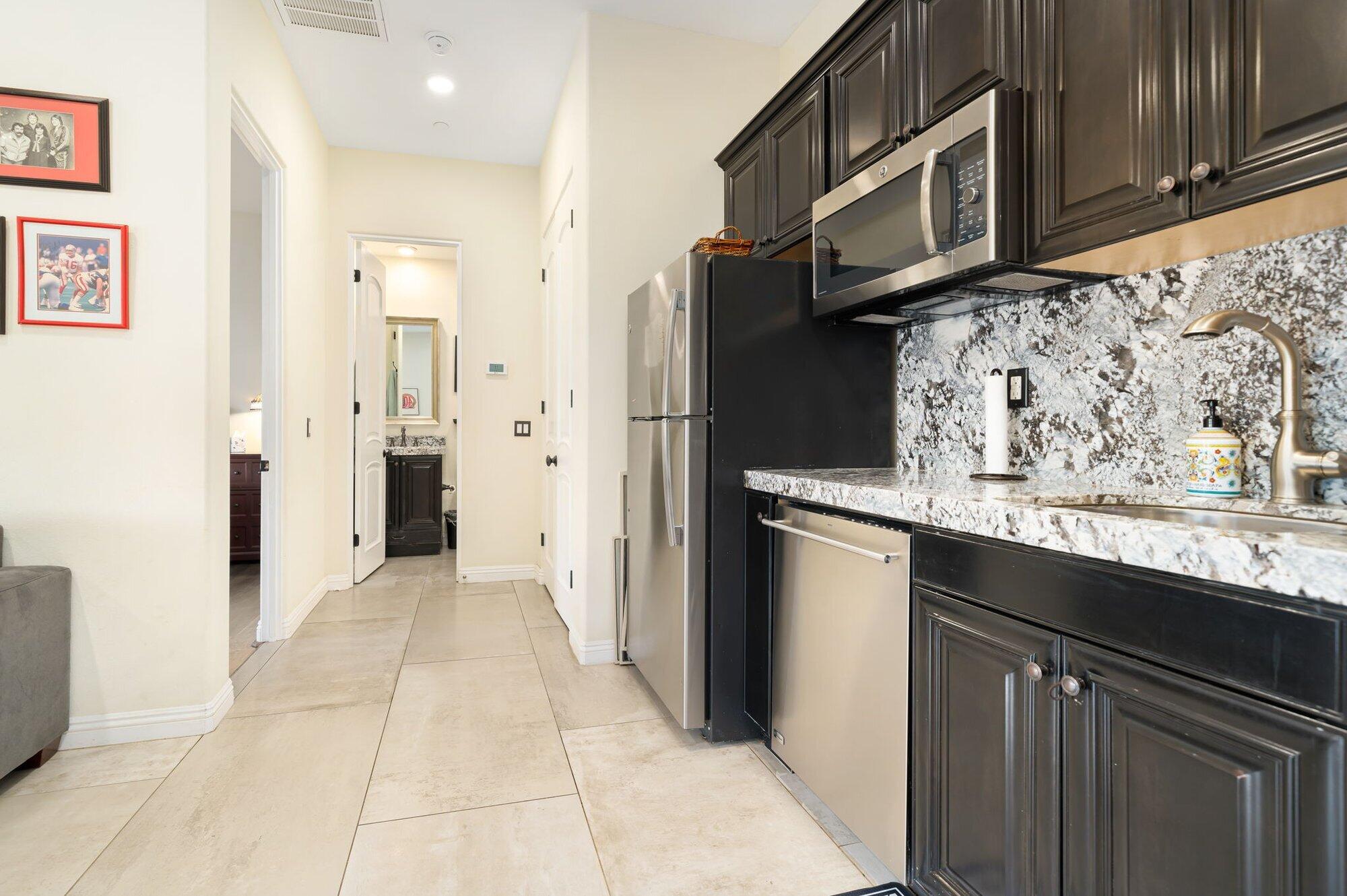 81675 Macbeth Street La Quinta, CA 92253 - Photo 45 of 76 a kitchen with stainless steel appliances granite countertop a refrigerator and a microwave