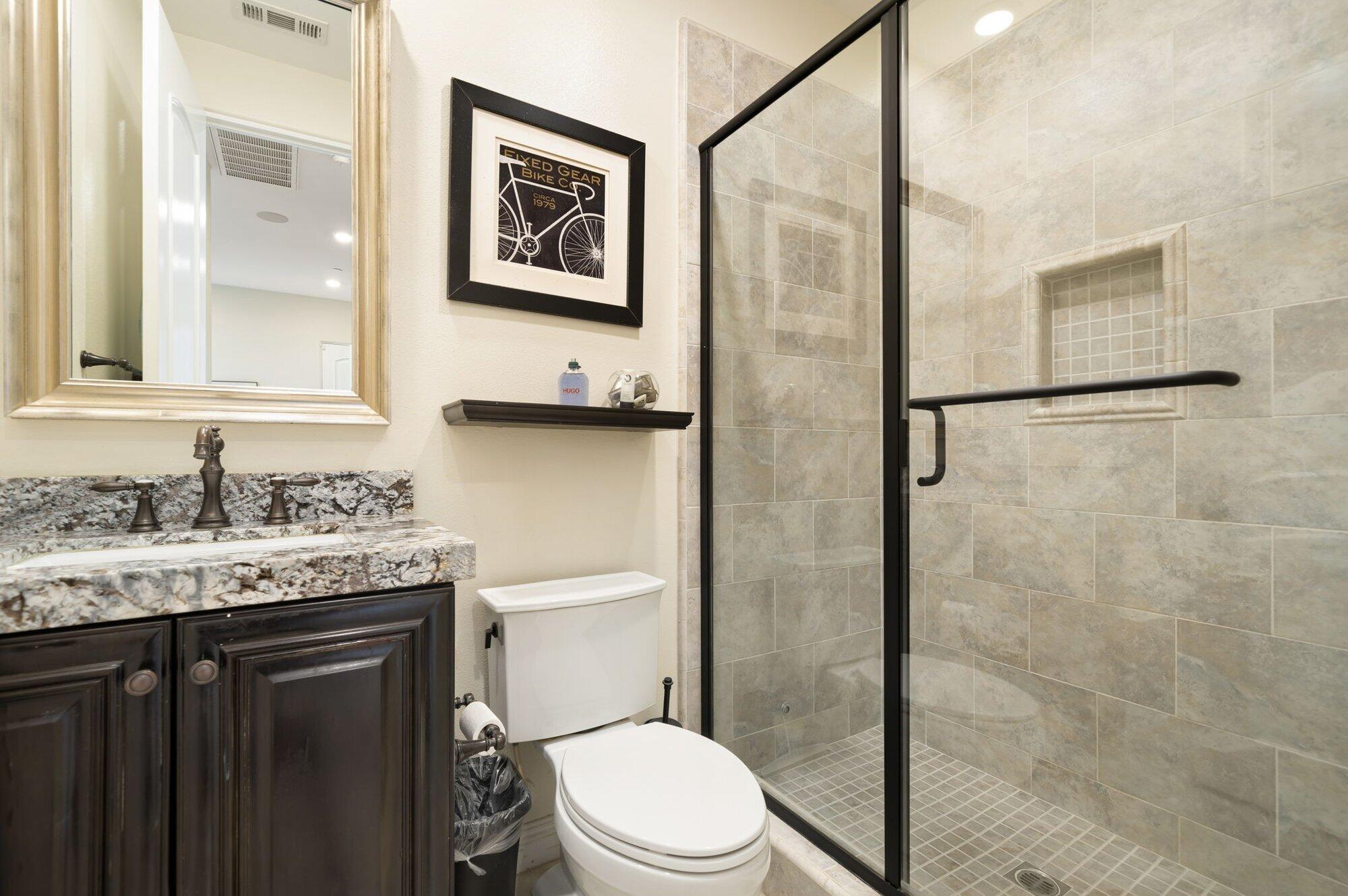 81675 Macbeth Street La Quinta, CA 92253 - Photo 46 of 76 a bathroom with a granite countertop toilet sink and shower
