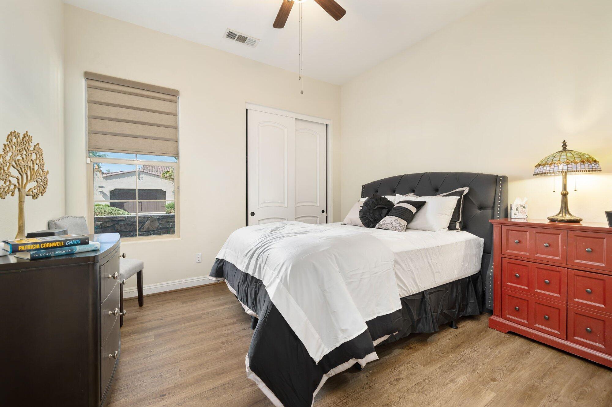 81675 Macbeth Street La Quinta, CA 92253 - Photo 48 of 76 a bedroom with a bed and wooden floor