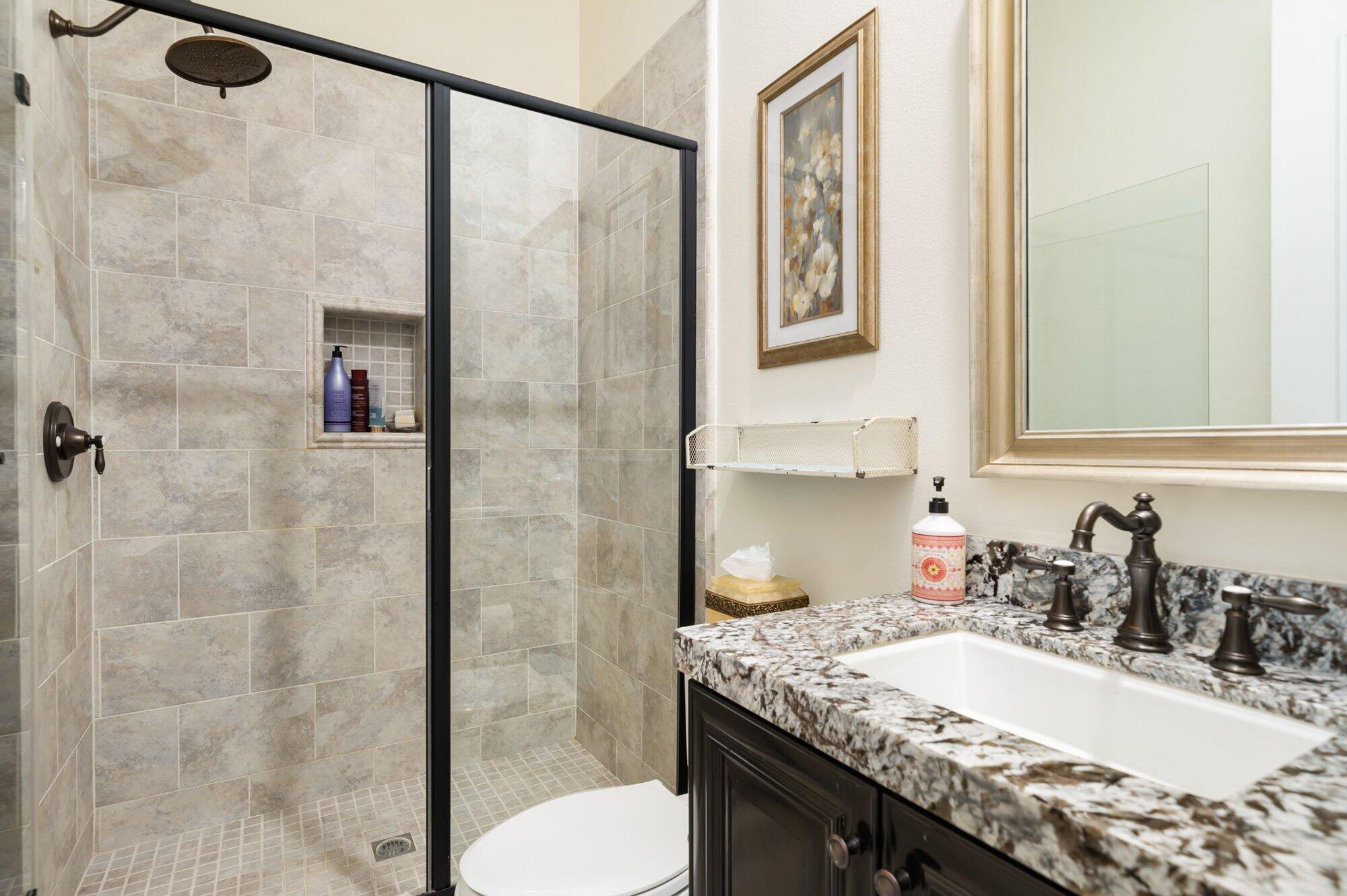 81675 Macbeth Street La Quinta, CA 92253 - Photo 51 of 76 a bathroom with a granite countertop sink a toilet and shower