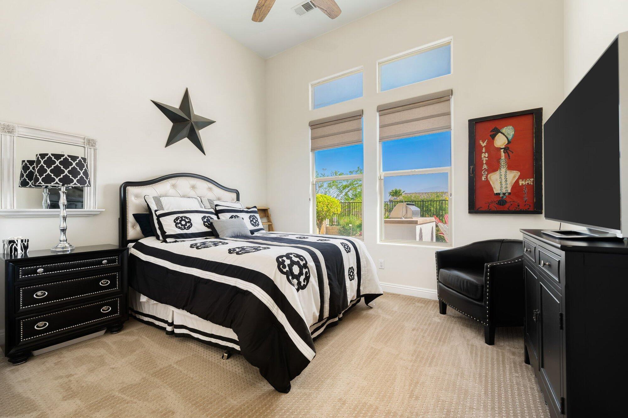 81675 Macbeth Street La Quinta, CA 92253 - Photo 52 of 76 a bedroom with a bed and a flat tv screen on dresser