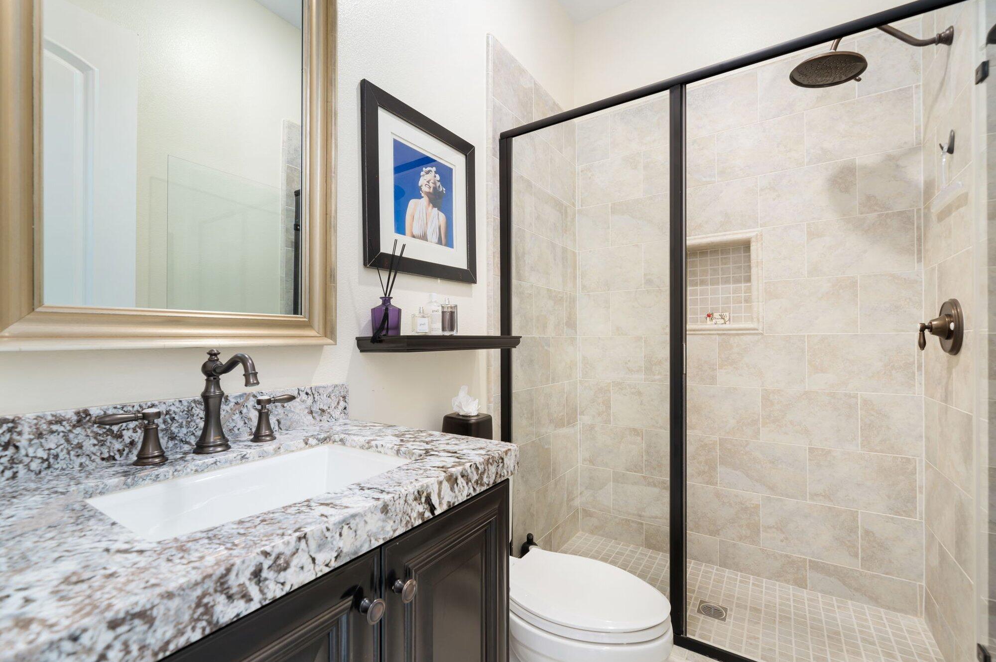 81675 Macbeth Street La Quinta, CA 92253 - Photo 53 of 76 a bathroom with a granite countertop sink a toilet and shower