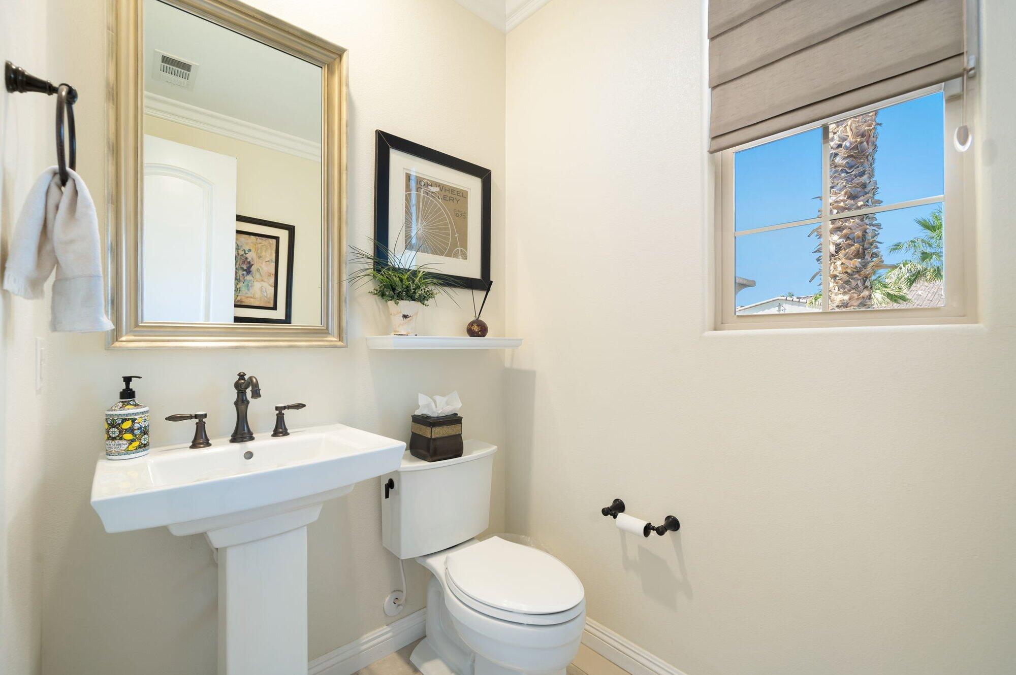 81675 Macbeth Street La Quinta, CA 92253 - Photo 54 of 76 a bathroom with a toilet a sink and mirror