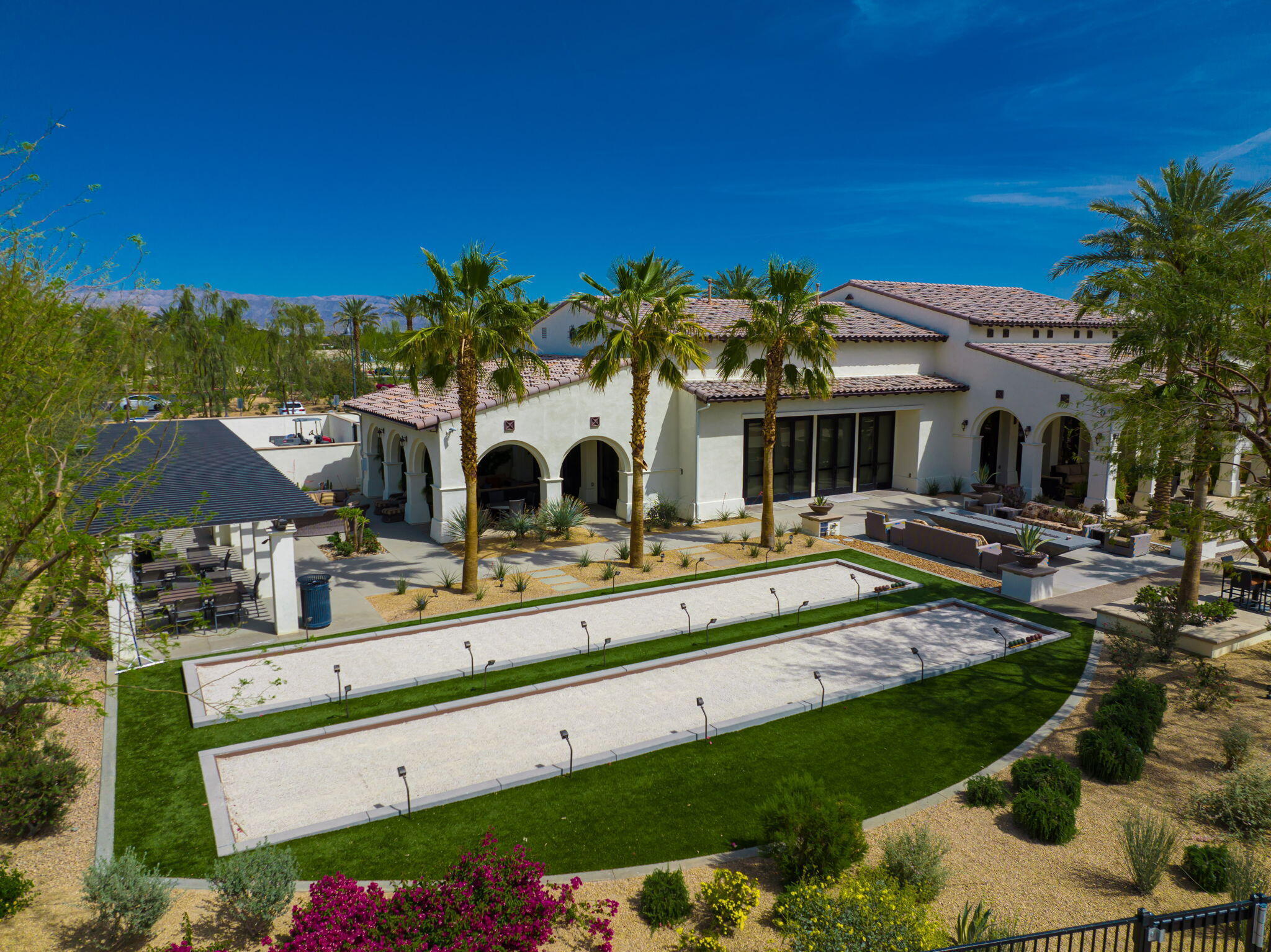 81675 Macbeth Street La Quinta, CA 92253 - Photo 64 of 76 a view of a white house with a big yard and potted plants