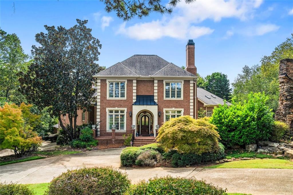 3832 Wesley Chapel Road Marietta, GA 30062 - Photo 1 of 1 a front view of a house with a garden