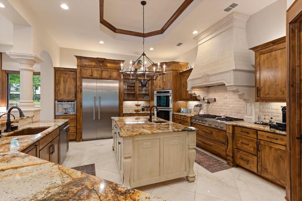 3705 Champions Ridge Lane Longview, TX 75605 - Photo 13 of 40 a kitchen with stainless steel appliances granite countertop a sink a stove and a refrigerator