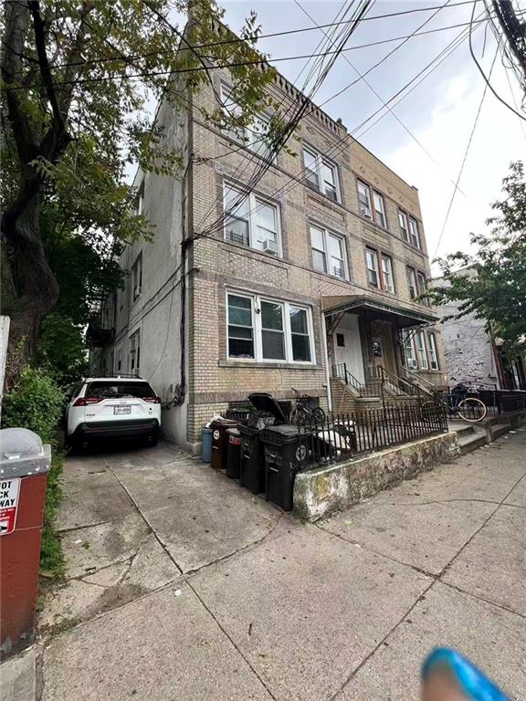 1564 Bay Ridge Avenue Brooklyn, NY 11219 - Photo 2 of 14 a car parked in front of a brick house