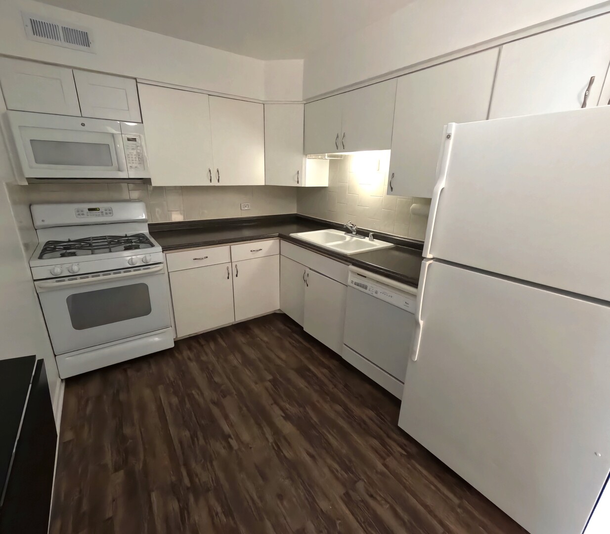 6325 North Sheridan Road, Unit 2003 Chicago, IL 60660 - Photo 4 of 17 a kitchen with cabinets a sink and appliances