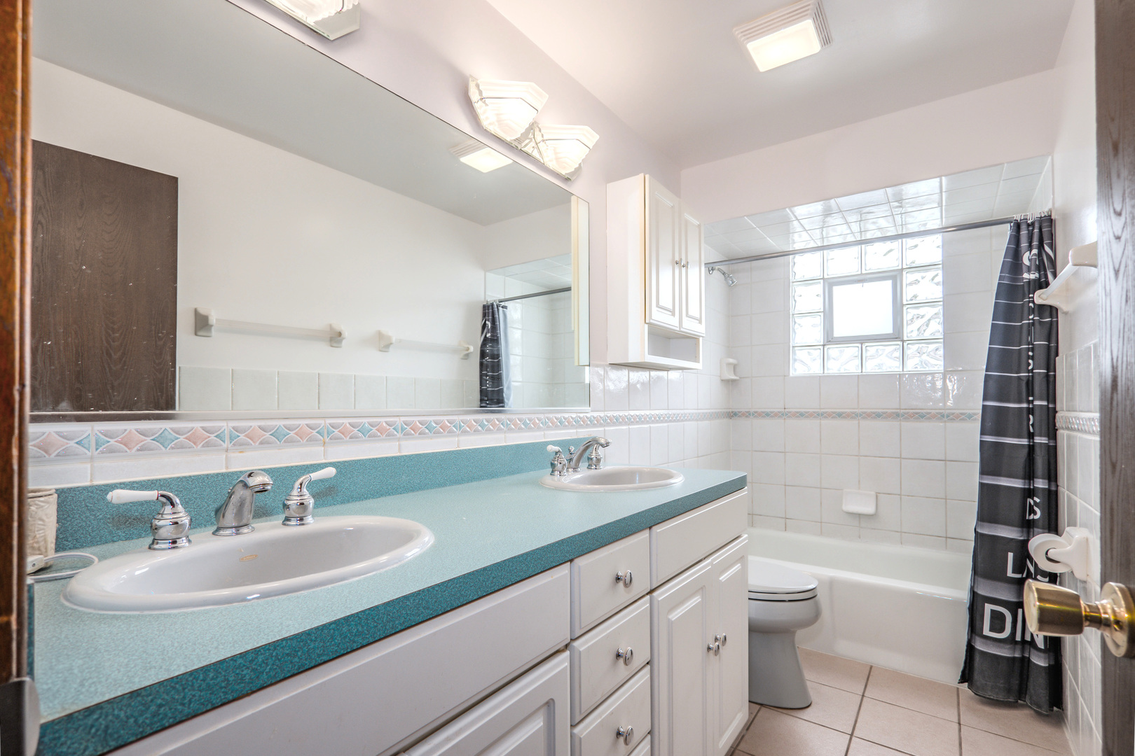 8440 Anvil Place Tinley Park, IL 60487 - Photo 13 of 18 a bathroom with a double vanity sink toilet mirror and shower
