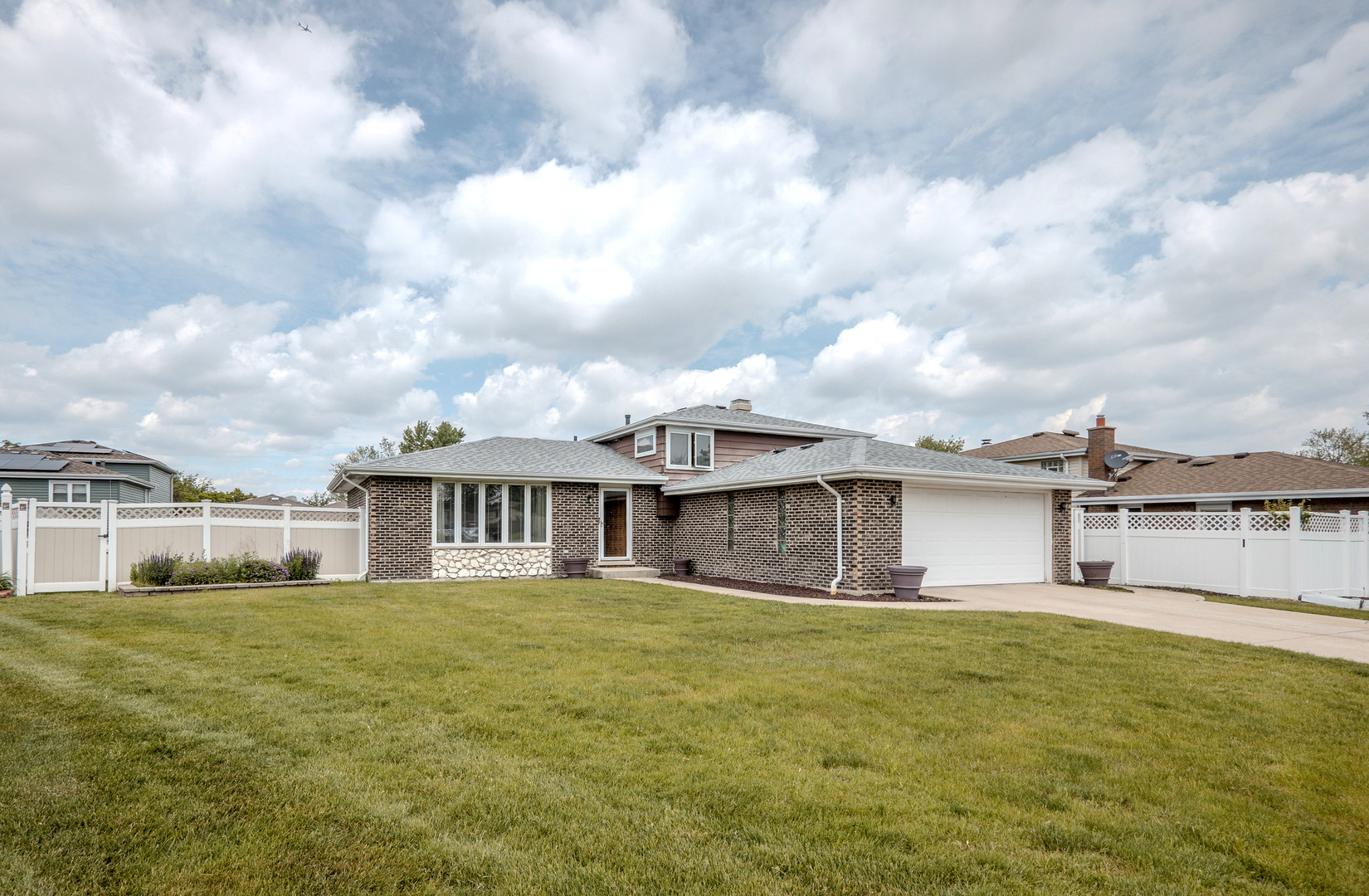 8440 Anvil Place Tinley Park, IL 60487 - Photo 2 of 18 a view of a house with a big yard and large trees