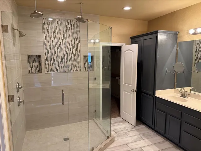 a bathroom with a shower and a sink