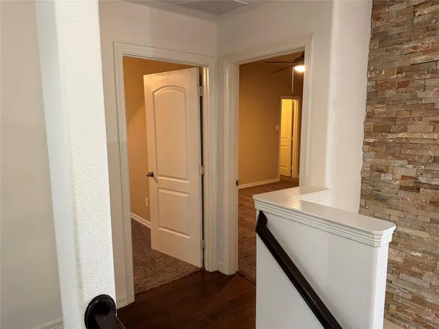 a view of walk in closet with wooden floor