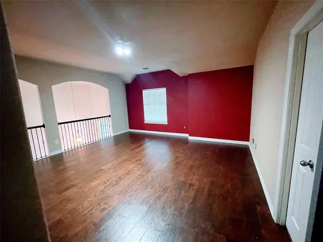 a view of gallery with wooden floor