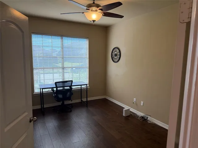 wooden floor and couch in a room next to a window