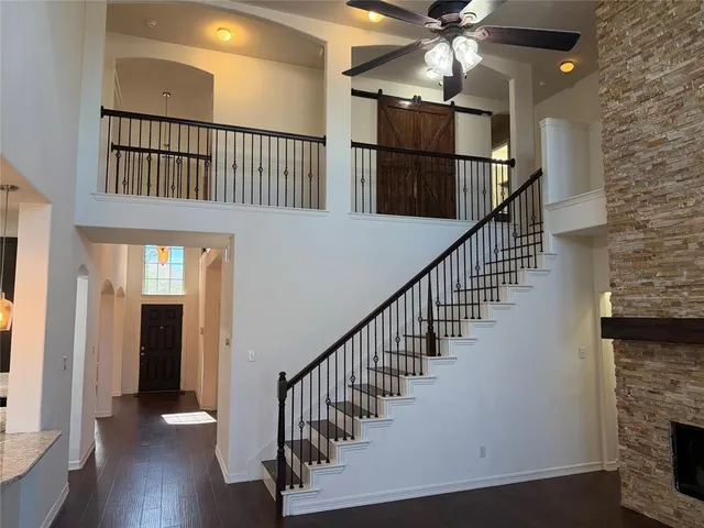 a view of staircase with wooden floor and a chandelier