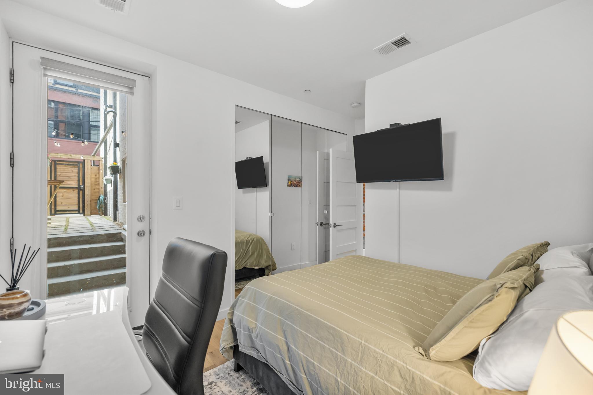 1324 W Street Northwest, Unit 1 Washington, DC 20009 - Photo 28 of 37 a bedroom with a bed and a flat screen tv