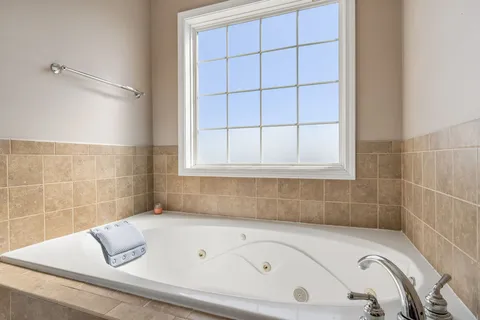 a view of hallway with furniture and a shower