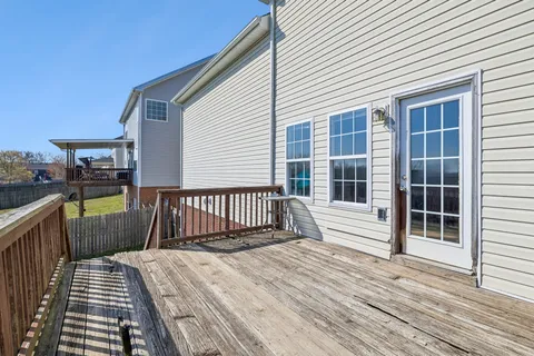 a view of a house with wooden deck