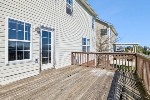 a view of balcony with wooden floor and fence