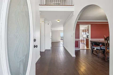 a room with table chairs and entryway