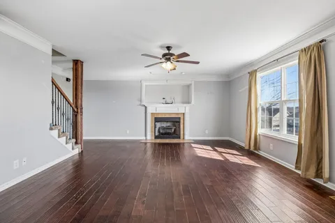 a view of a livingroom with furniture wooden floor and a window