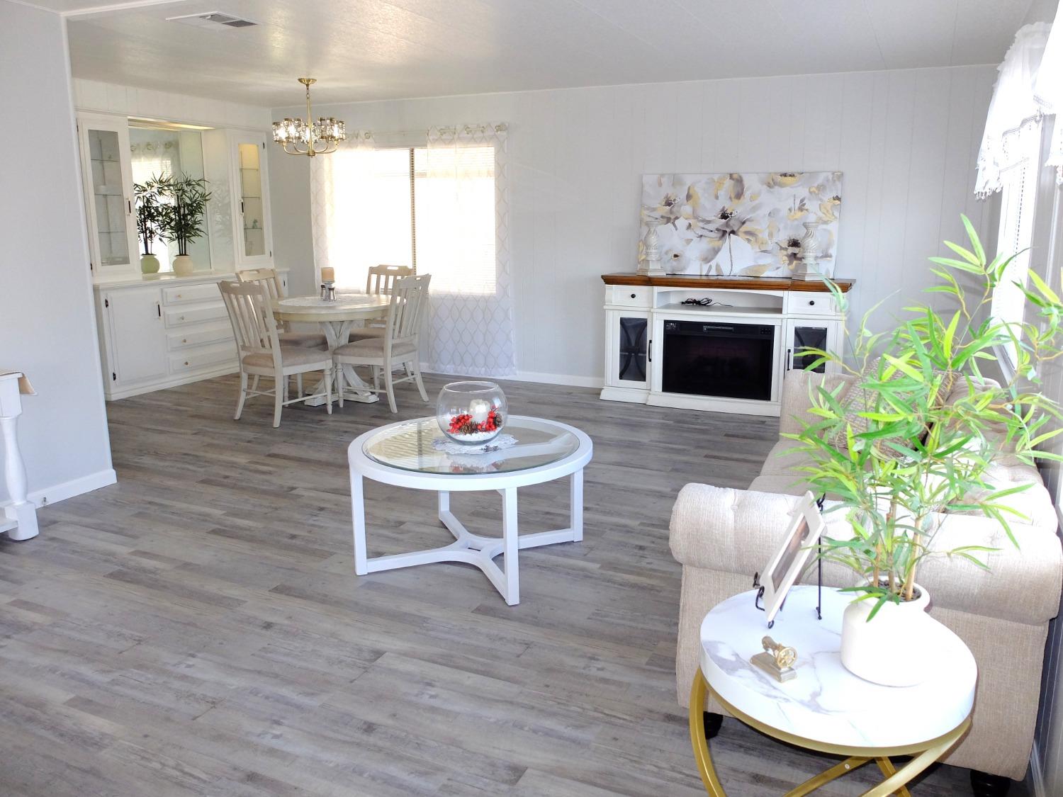 a living room with furniture a fireplace and a potted plant