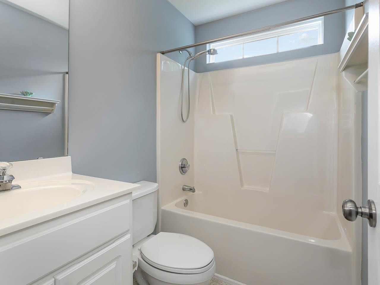 3702 Appling Way Durham, NC 27703 - Photo 19 of 34 a bathroom with a sink a toilet and shower